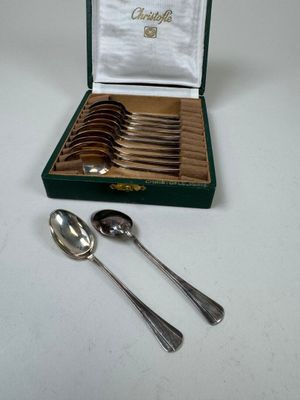 silverware in a green box with a white napkin and a silver spoon