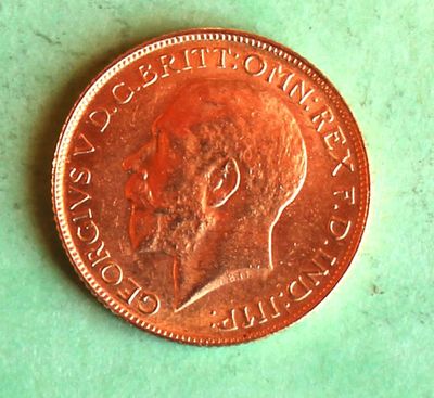 a penny on a table with a green background