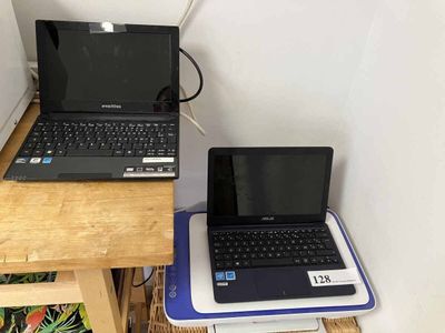 two laptops that are sitting on a small table