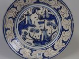 a blue and white plate with a design on it