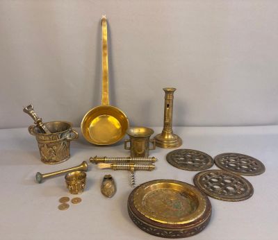 several brass objects are sitting on a white surface