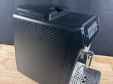 a black coffee machine sitting on top of a wooden table