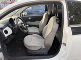the interior of a small white car with the door open