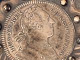 a silver coin with a picture of a woman on it