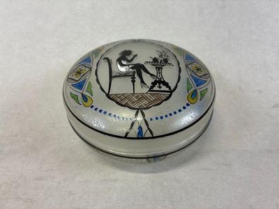 a silver box with a picture of a woman sitting on a chair