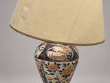 a lamp that is sitting on a table with a lamp shade on it