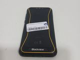 a black and yellow cell phone with a barcode on it