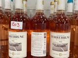 several bottles of wine are lined up on a counter