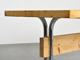 a wooden table with metal legs and a wooden table top