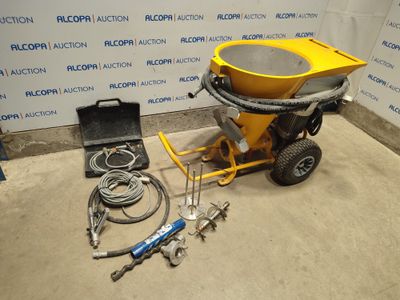 the concrete mixer is sitting on the floor next to the tools