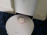 a robot that is sitting on the floor next to a toilet