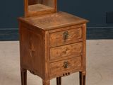 an old wooden dresser with a mirror on top of it