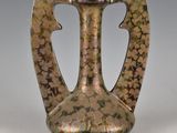 a vase that is sitting on a table with flowers on it