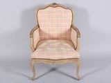 an old fashioned chair with a plaid upholstered seat