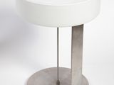 an image of a white table with a lamp on it