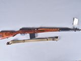 a rifle and a knife on a table next to each other