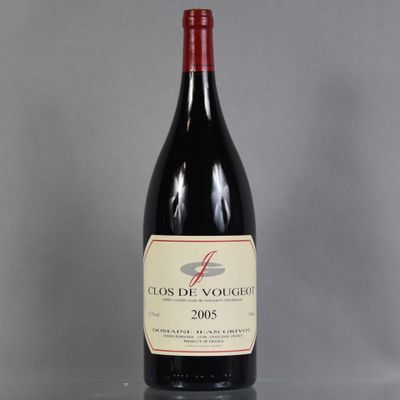 a bottle of red wine sitting on top of a table