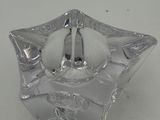 a glass candle holder with a candle inside of it