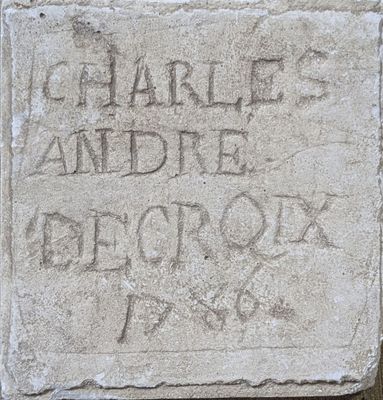 a stone sign that says charles and the electric box