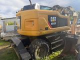 a large yellow construction vehicle that is parked in the grass