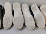 five pairs of shoes lined up in a row on a table