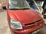 une voiture rouge garée dans un garage, très sale