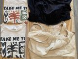 three t - shirts that are sitting on a wooden crate