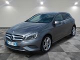 the mercedes cla is parked on a checkered floor in a garage