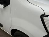 a white van that is parked in a parking lot