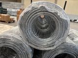 three rolls of wire wrapped in plastic sitting on a pallet