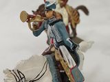 a figurine of a man riding a horse with a sword