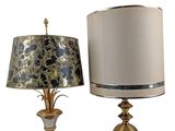 pair of gold and silver lamps with shades on each of them