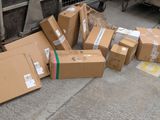 many boxes that are sitting on the ground next to a truck