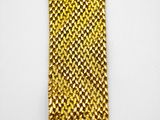 a close up of a gold metal bracelet on a white surface