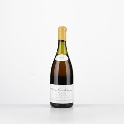 a bottle of wine sitting on top of a white table