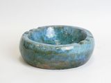 a blue bowl that is sitting on a white surface