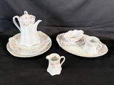 three pieces of porcelain tea and coffee set on a black background