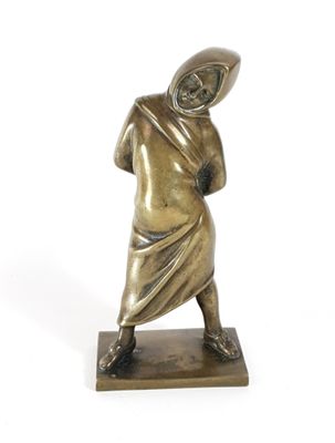 bronze statue of a man with a hood on his head holding a baseball bat