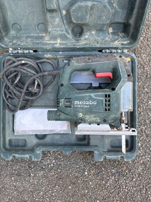 a tool in a case that is sitting on the ground