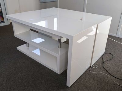 a white desk with a lamp on top of it