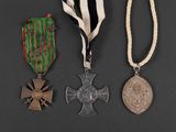 three medals and a medal on a black background