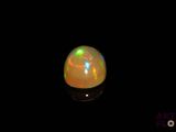an image of a white fire opal in the dark