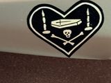 a heart shaped sticker with a skull and crossbones on it