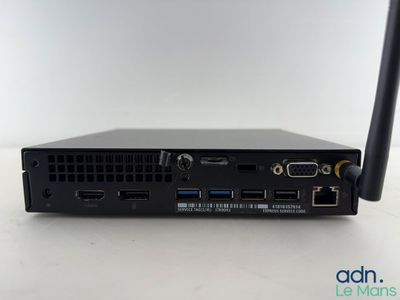 a close up of a small black computer on a white surface