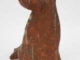statue of a dog made of clay on a white background
