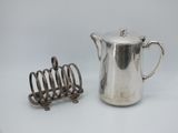 a silver coffee pot and a toaster on a table