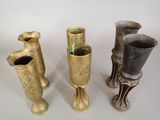 four different types of vases sitting on top of a white surface