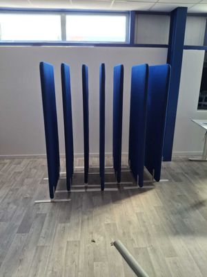 a room that has a bunch of blue partitions in it