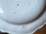 a white plate with a sticker on it sitting on a table