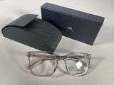 sunglasses in a box and a pair of glasses on a table
